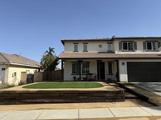 Final product, retaining wall was built, leveled with the patio with Dg planters and steps leading to the front entrance