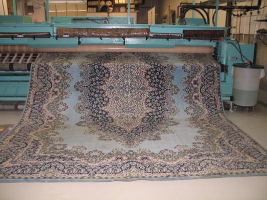 Rug coming out of the machine and ready for drying.