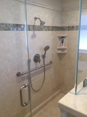 Easy access shower stall with heavy glass enclosure.