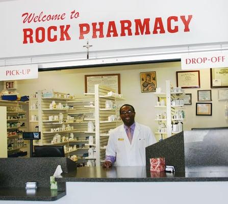 Peter Orakewe, President / Owner/ Pharmacist at the front counter of Rock Pharmacy