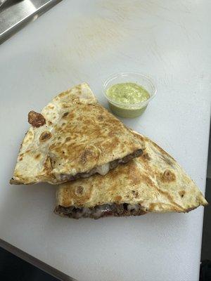 Beef Fajita Quesadilla with avocado green sauce.