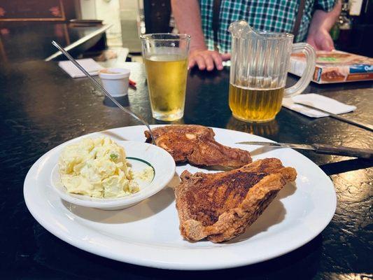 Pork chop dinner. Potato salad, small pitcher of Bud Light draft beer.