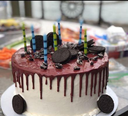 Oreo Cake. White icing/Maroon Icing Drip/Oreo Cookie Crumble!