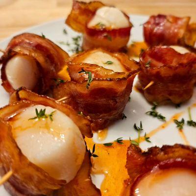 Stonington scallops wrapped in bacon topped with a maple sriracha sauce