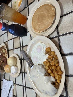 Chicken fried steak with 2 eggs, home style potatoes, and pancakes