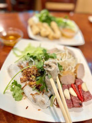 Bánh Cuon, steamed rice roll, stuffed with grounded pork & mushroom, fried shallot, fresh herbs, bean sprout, ham topping, and more