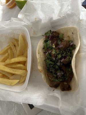 Rib-eye Steak Tacos and french fries. Lots of cilantro and some red onion on the taco.