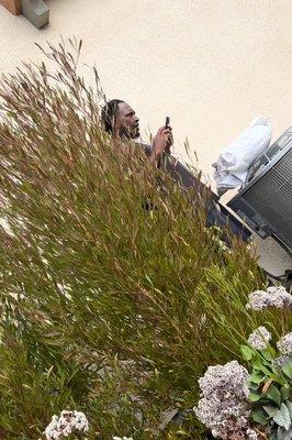 Homeless person using residents electricity on the side of their house without permission.