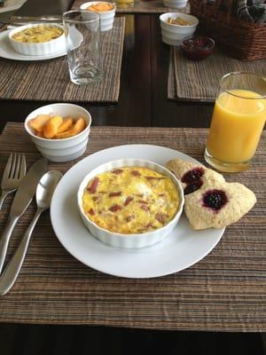 Delicious gourmet breaky: oven baked eggs w/ grated potatoes on the bottom & fresh made berry scones & jam!!