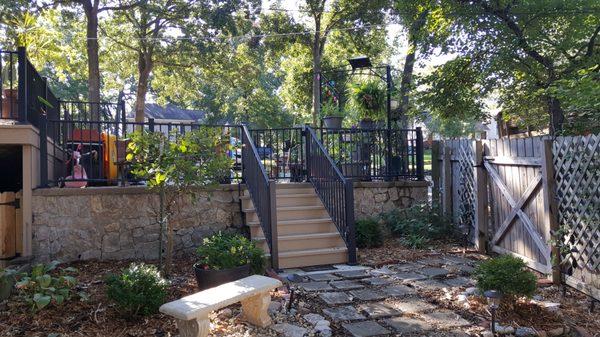 Terraced patio and backyard seating area w/ Fortress AL13 railing, stairs and KS Cut Limestone on the wall