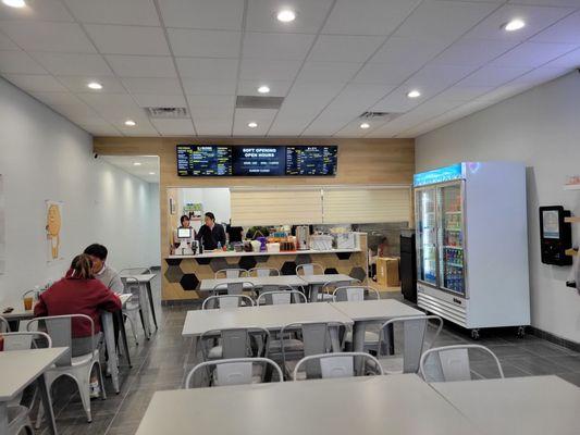 Front of the counter and ordering kiosk on the far right wall.