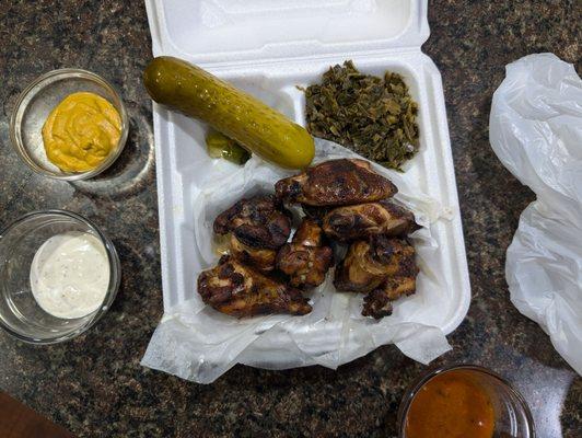 Smoked to go wings with greens and my sauces with spicy pickle!