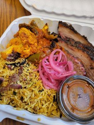 Sliced brisket with two sides; Cauliflower Manchurian and Brisket Biryani with hot bbq sauce on the side