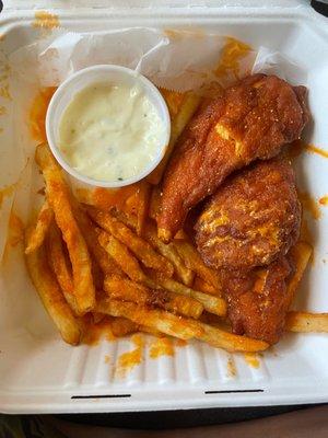 Soggy microwaved chicken fingers sitting on top of the literal handful of fries, making them soggy and gross too.