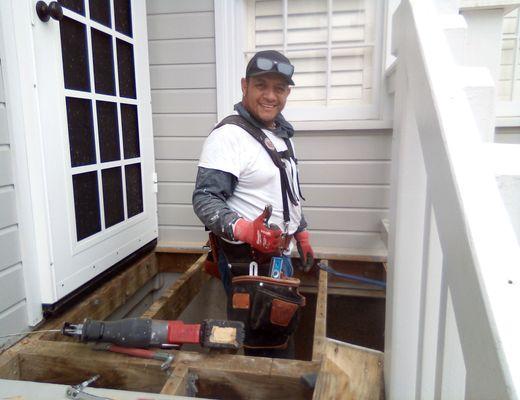 Juan working on the back porch which required new decking and steps.