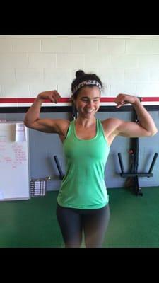 Sarah throwing up double bicep shot after 30 lb. fat loss at Rogue Training Garage!