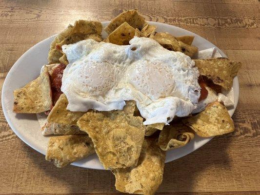 Huevos Rancheros. This is actually a bean burrito (beans in folded flour tortilla), with sauce topped by eggs and surrounded by chips.