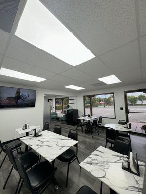 The eating area accomodates 14 people in terms of chairs and tables.