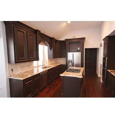 Granite countertops, hickory hand scrape hardwood flooring and split face travertine back splash. This remodeling job was done in Katy TX.