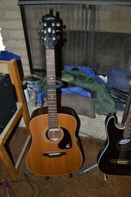 Epiphone PR 350S acoustic; cheapest one I saw (used) on eBay was $269. I paid $125 @ Mustang. ('Scuse the mess)