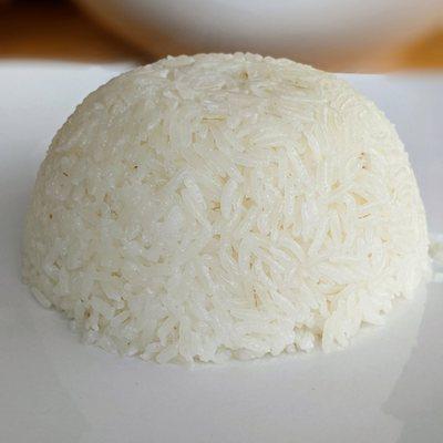 A dome of rice on a white plate. Legend has it that monks learn the craft of rice placement-- wait, it's formed with a bowl? Okay then.