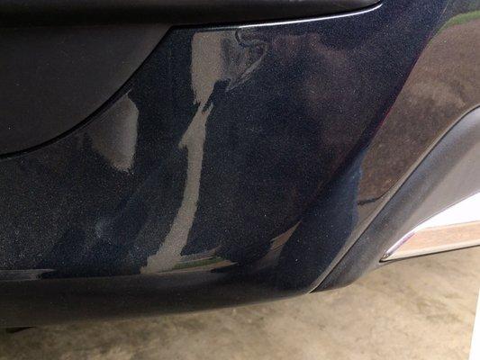 Rear left side of bumper where paint is runny.