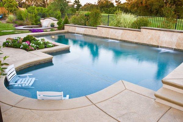 Pool with raised tile back splash and sheer descents.