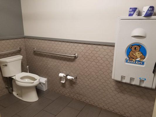 Diaper station in larger of 2 stalls