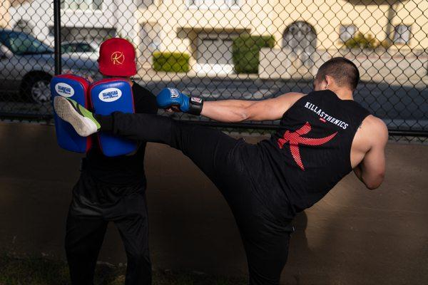 MMA and strength conditioning Coach Brian hitting the pads