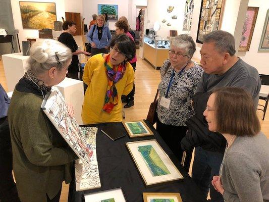 Artist Nerys Levy giving a demo during a class on the inspiration and techniques behind her artwork.