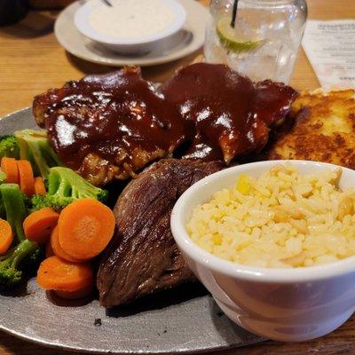 Baby back ribs and ribeye steak combo with veggie meals and rice pilaf