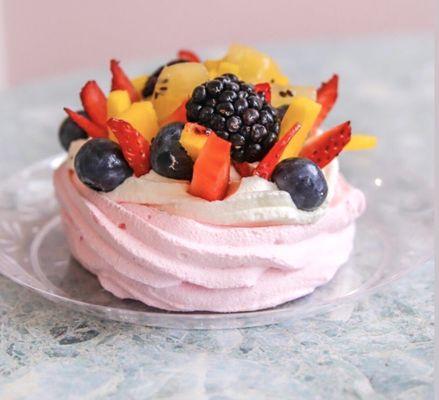 Pavlova- A gluten-free dessert made from our housemade merengue rose water tart and topped with fresh whipped cream and fruit.