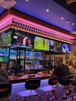 Large bar with big screens set on NFL football and boxing for the sports enthusiast