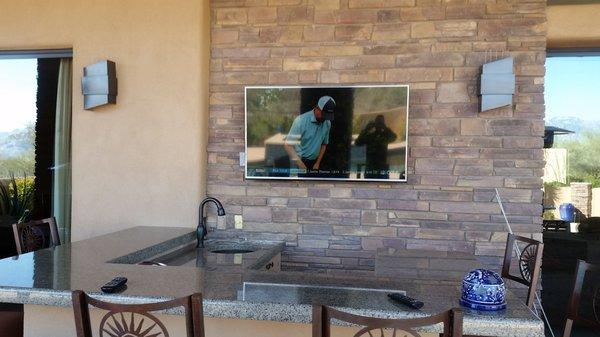 55 inch TV on an articulating mount, on brick, hidden wiring, outside patio