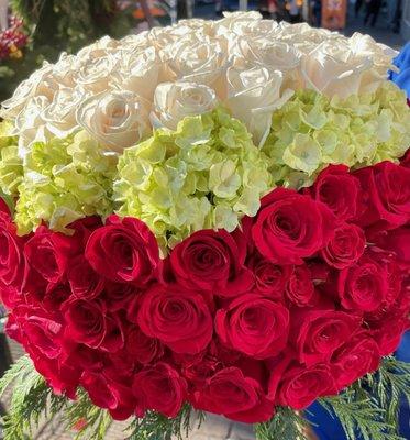 Lush bouquet of red and white roses with hydrangea.