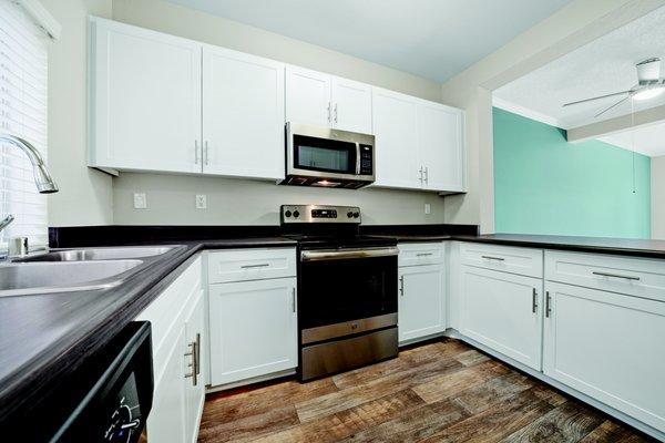 Stainless steel appliances with woodgrain style countertops