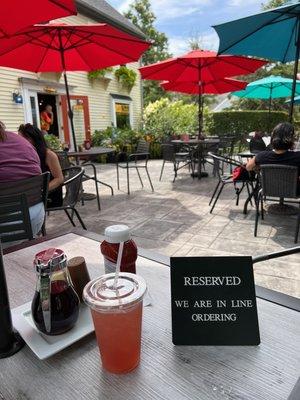 Seating outside, table reserved for us by host as we wait in line to order.