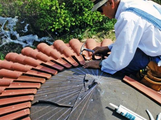 Installation of clay tile on turret roof.