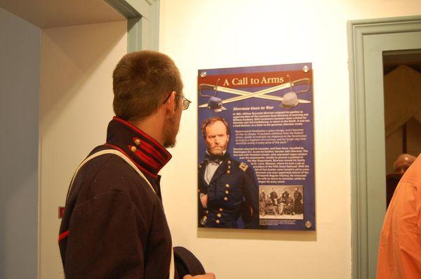 A Civil War reenactor views one of the new story panels.