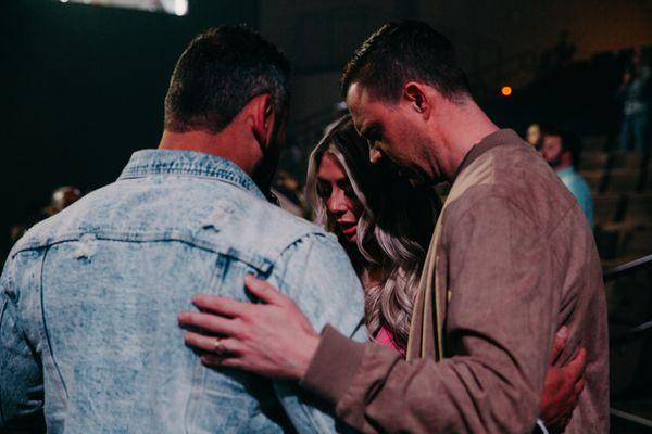 Couple praying with the prayer team during worship