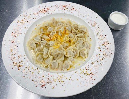 Pelmeni - homemade meat dumplings in clear broth