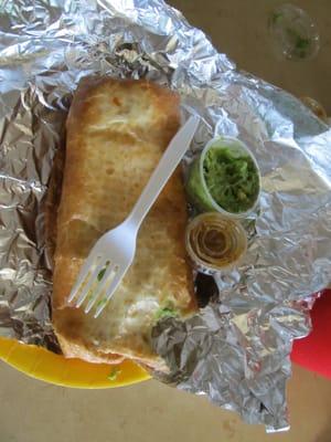 Steak chimichanga with small side of guac and hot sauce. Yum!