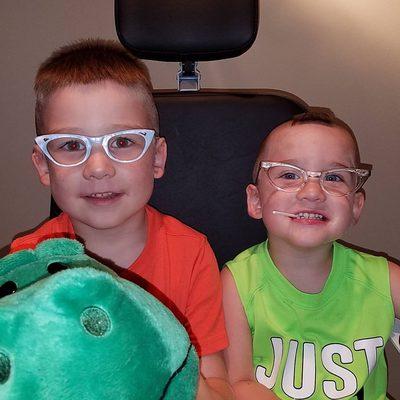 2 Goofy little boys who like to play with glasses.