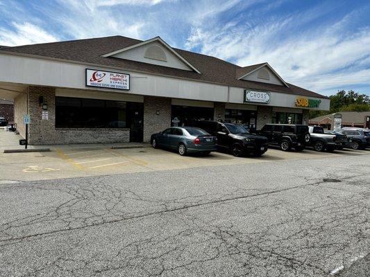 No overhead sign (YET!). In this strip of shops. Accessible parking and plenty of parking around the building.