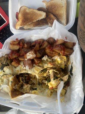 Home fries, toast, and a chicken and cheese omelet with spinach, onion and peppers. This is to die for!! So good!