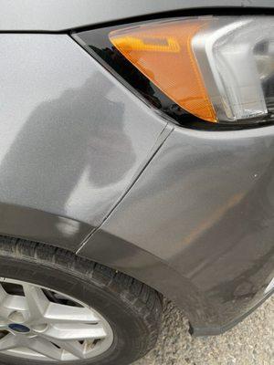 More unrepaired accident damage on a bumper held together with string.