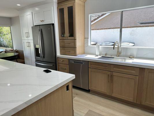 Cabinets, refrigerator, sink, countertops.