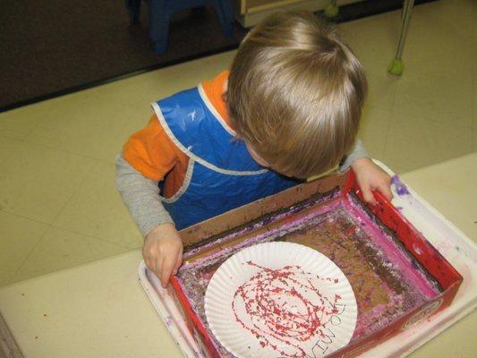 Using fine motor skills at the art table.