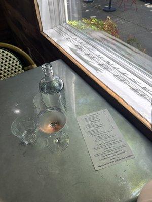 Solo tasting at a cool table with a snapshot of the day's menu