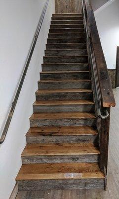 Stair clad in reclaimed barn wood with steel and barn wood banister.